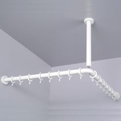 a white pipe is hanging from the ceiling