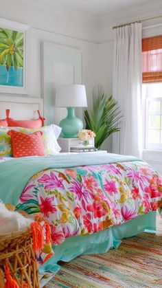 a bedroom with colorful bedding and pictures on the wall above it, along with wicker baskets