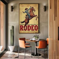 an old rodeo poster hangs on the wall above a dining room table with orange chairs