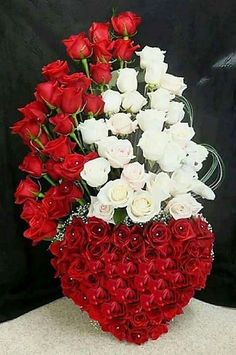 red and white roses arranged in a heart shaped arrangement with the number twenty five on it