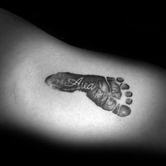 a black and white photo of a baby foot with the word ava on it's side