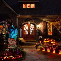 a house decorated for halloween with pumpkins and decorations