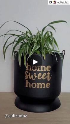 a potted plant with the words home sweet home written in gold ink on it