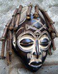 an african mask is displayed on the wall