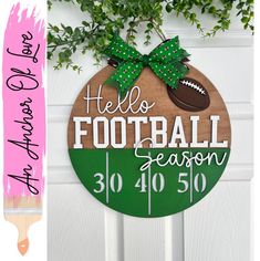 a wooden sign that says hello football season 30 / 40 / 50 with a green bow on it