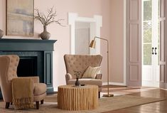 a living room with pink walls and furniture