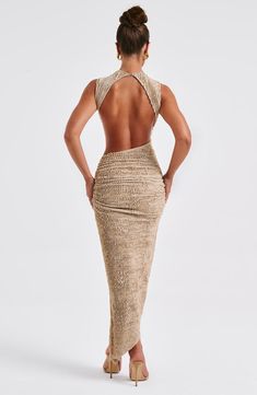 Crafted in our textured stretch fabric that hugs every curve, the Aphrodite midi features an asymmetric skirt with thigh high split. The high neck design is complete with a showstopping open back detail. Style yours with heeled mules and sleek waves. 



Colour: Beige.

Textured stretch fabric.



Open low back.

Asymmetric skirt.

Thigh high split.

Button closure at back neck.

High neck.

Midi length.

Model is an XS and is wearing an XS.

 Size: XS, S, M, L, XL, XXL