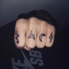 a man's fingers with tattoos on them and the number four in each finger