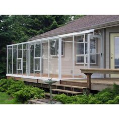 a small house with lots of windows on the front porch