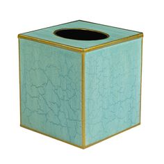 a blue square tissue holder with gold trim