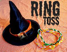 a witch's hat and bracelet are on a table with the words ring toss