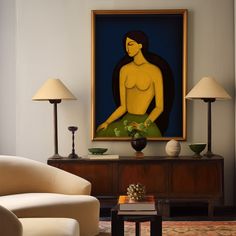 a living room with a painting on the wall next to a couch and two lamps