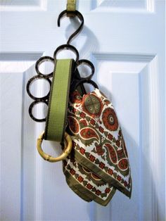 a purse hanging on a door handle with a key ring attached to the front of it