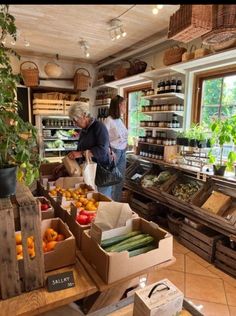 two people standing in a store filled with produce