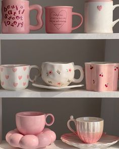 pink and white coffee cups on shelves with hearts