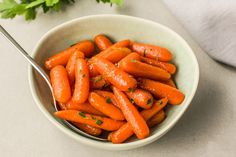 a white bowl filled with carrots on top of a table