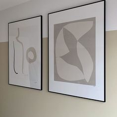 two framed art pieces hang on the wall