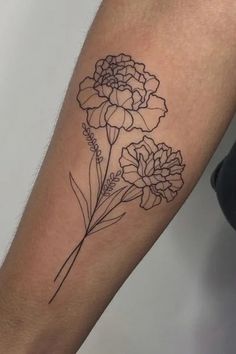 a black and white photo of a flower on the left arm, with two flowers in it