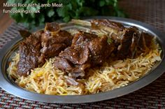 some meat and rice on a metal plate