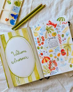 an open notebook with the words welcome summer written on it next to watercolor paints and pencils