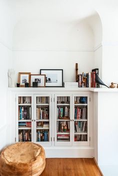 a white bookcase filled with lots of books