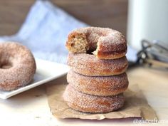 a stack of doughnuts sitting on top of a white plate