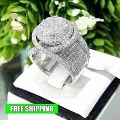 an image of a ring on top of a box with flowers in the back ground