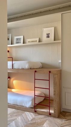 two bunk beds in a room with white walls