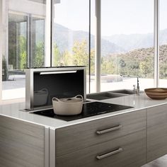 a kitchen with a stove top oven sitting next to a bowl on a countertop