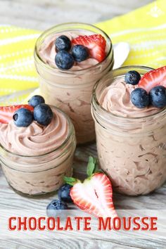 three jars filled with chocolate mousse and strawberries