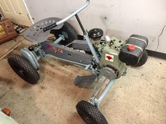 a toy car sitting on the floor in a room with other toys and equipment around it