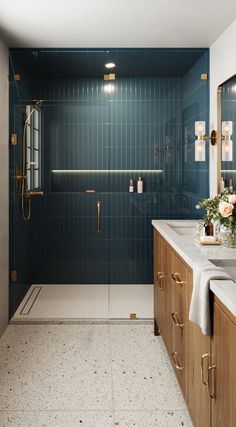 a bathroom with blue tile and wooden cabinets