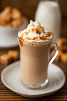 a cup of hot chocolate with marshmallows and caramel on the side