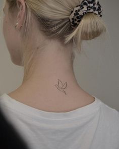 a woman with a small tattoo on her neck