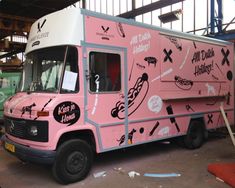 an ice cream truck is painted pink and white with stickers all over the side