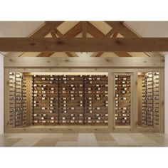 an empty room with wooden wine racks in the wall and wood beams on the ceiling