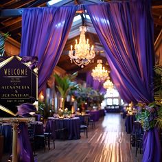 a purple and gold decorated hall with chandeliers