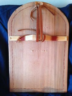 a wooden cutting board with two knives on it