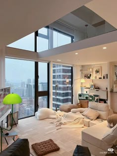 a living room filled with furniture and tall windows