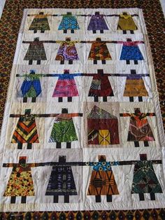 a quilted wall hanging with many different designs on it