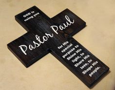 a wooden cross with the words pastor paul on it sitting on top of a chair