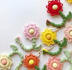 several crocheted flowers with names on them