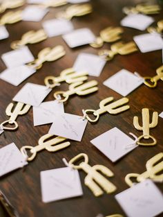 the table is covered with lots of cards and gold metal objects that are attached to each other