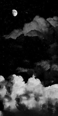 black and white photograph of the night sky with clouds