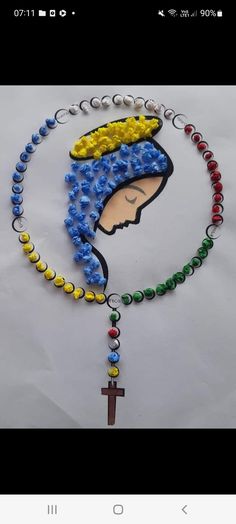 a rosary with beads and a crucifix in the shape of a woman's head