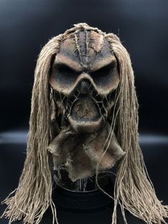 a creepy looking mask with long hair