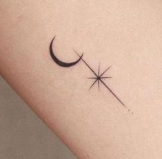 a small crescent and star tattoo on the left side of the arm, which is black