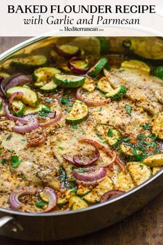 a pan filled with vegetables and sauce on top of a wooden table