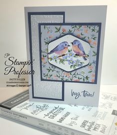 a card with two birds sitting on top of each other