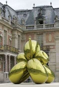 an artistic sculpture in front of a large building